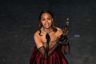 US actress Zoe Saldana accepts the award for Best Actress in a Supporting Role for "Emilia Perez" onstage during the 97th Annual Academy Awards at the Dolby Theatre in Hollywood, California on March 2, 2025.