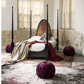 gothic theme bedroom with black bed and rose wool silk rugs