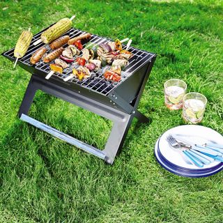 foldable barbecue outdoor with corn and veggies
