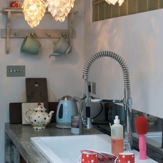 kitchen with white wall wash basin and cup hanger