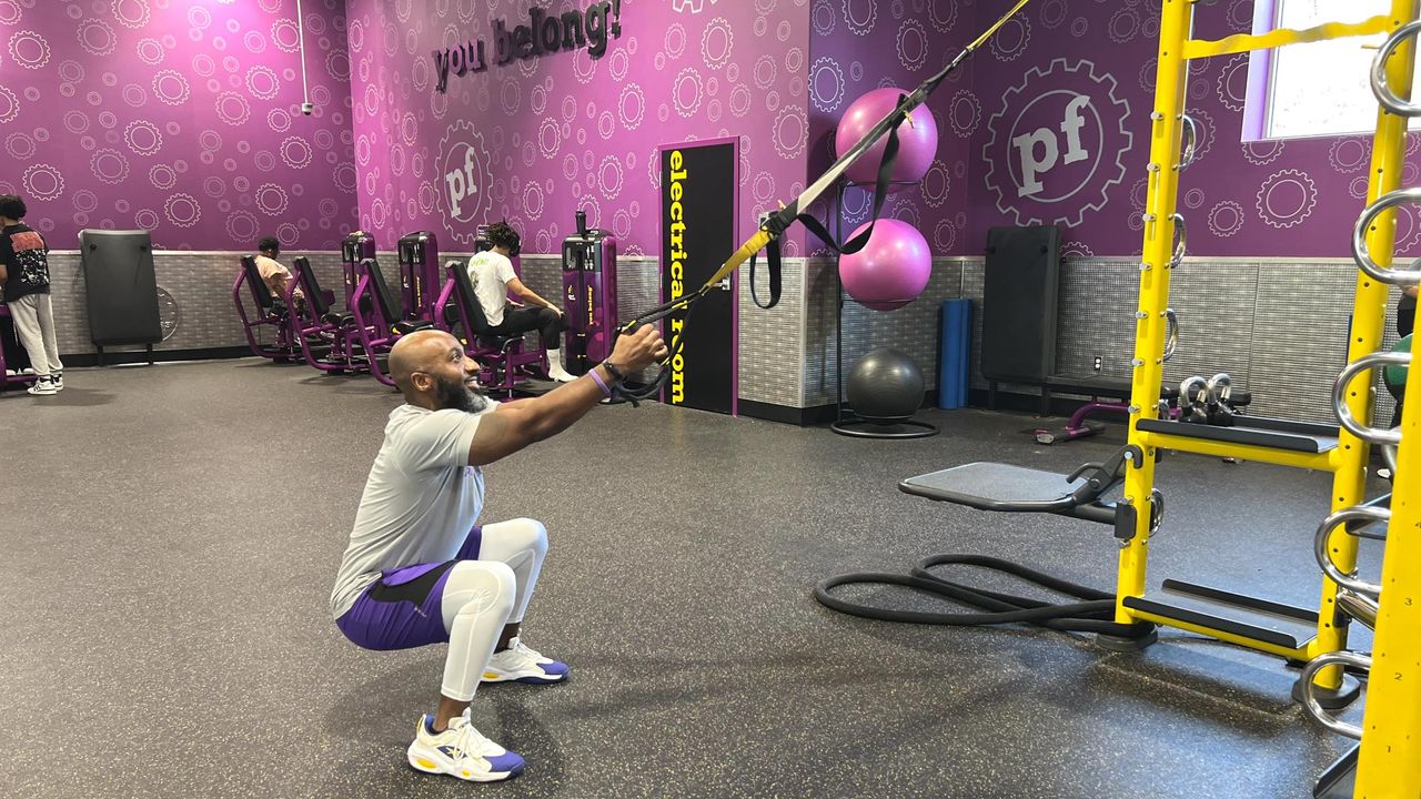 Teddy Savage performing a TRX squat jump