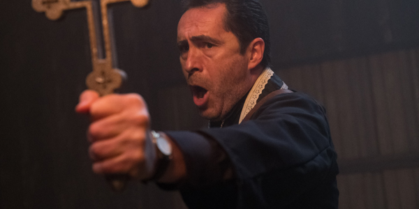 The Nun Father Burke (Demian Bichir) holds a cross