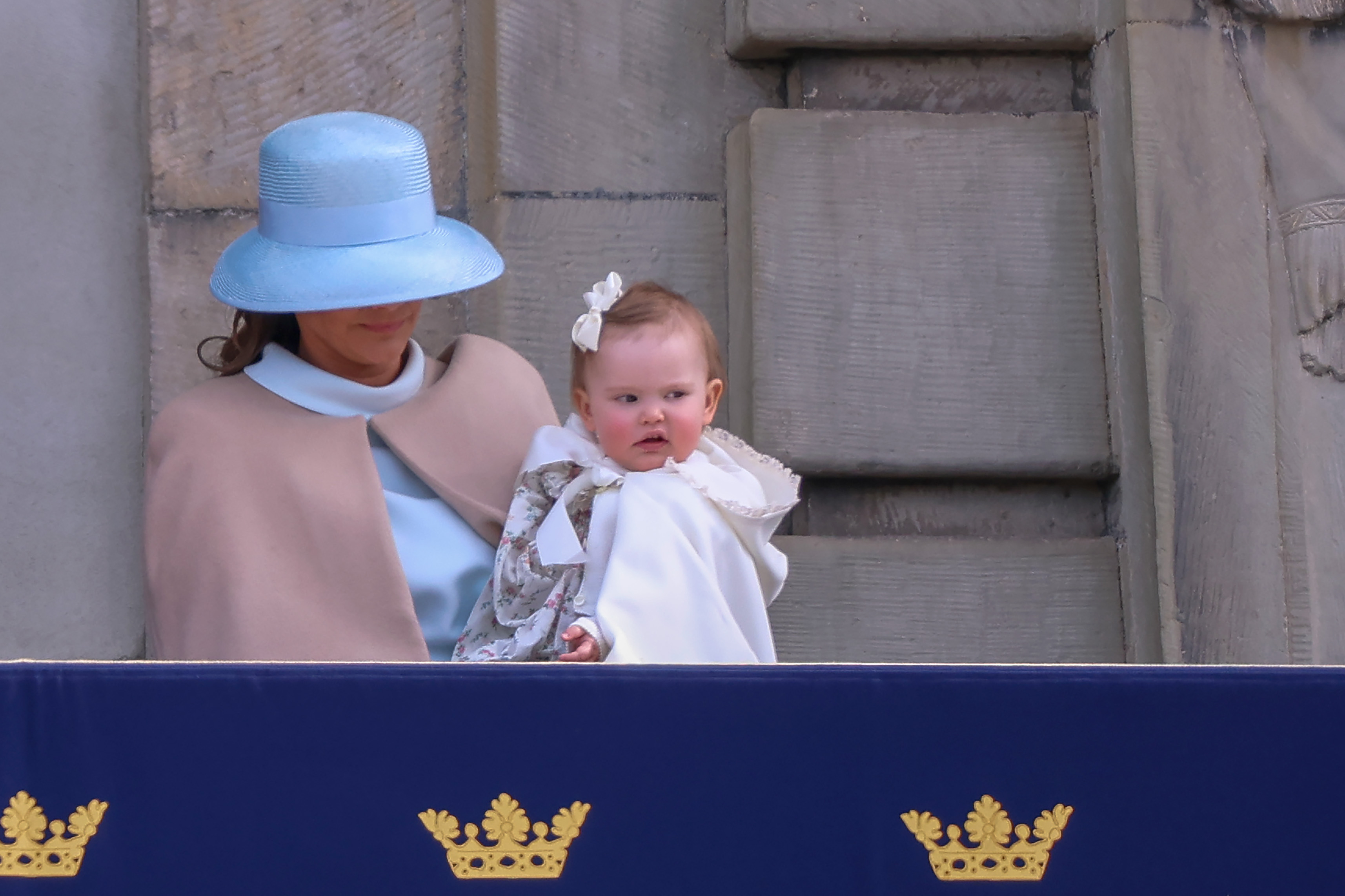 Princess Sofia wearing a blue hat holding Princess Ines