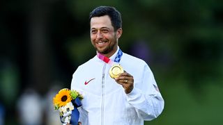 Xander Schauffele poses with the gold medal at the 2020 Olympics