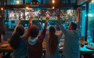 EverPass fans in a bar cheering sports