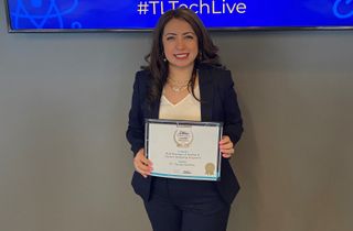 Dr. Claudia Martinez smiles holding her innovative leader award.