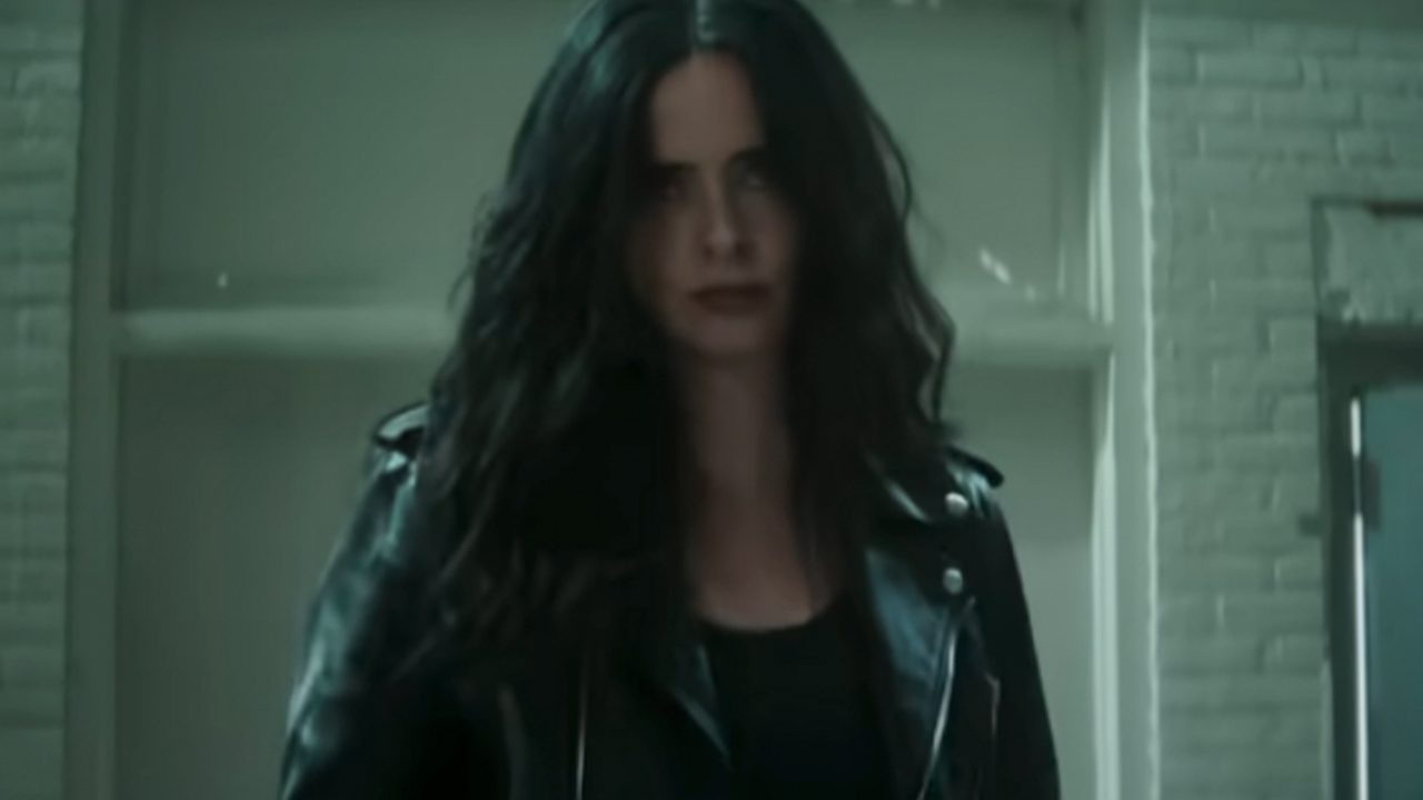 Krysten Ritter in a leather jacket, looking serious as Jessica Jones in Daredevil: Born Again Season 2