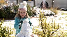 South African girl building snowman
