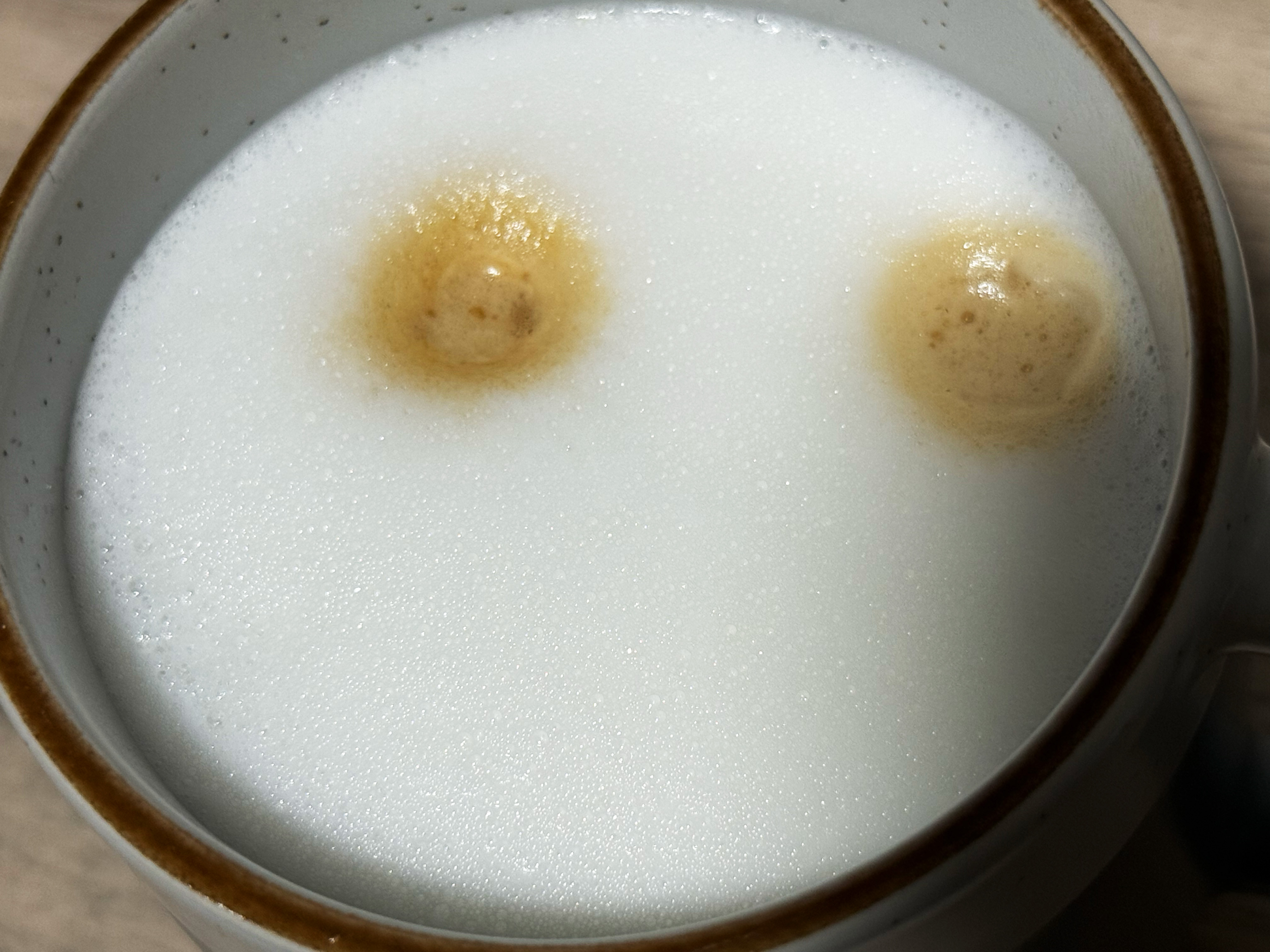 a close up photo of dense milk made on the delonghi rivelia