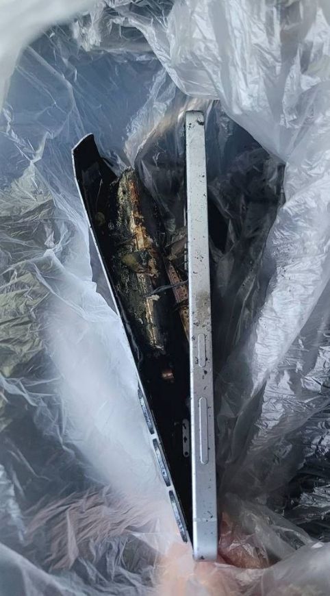 a burned Galaxy S25 Plus with its back panel peeled off