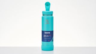 Takeya Active stainless steel water bottle on a desk with lid open