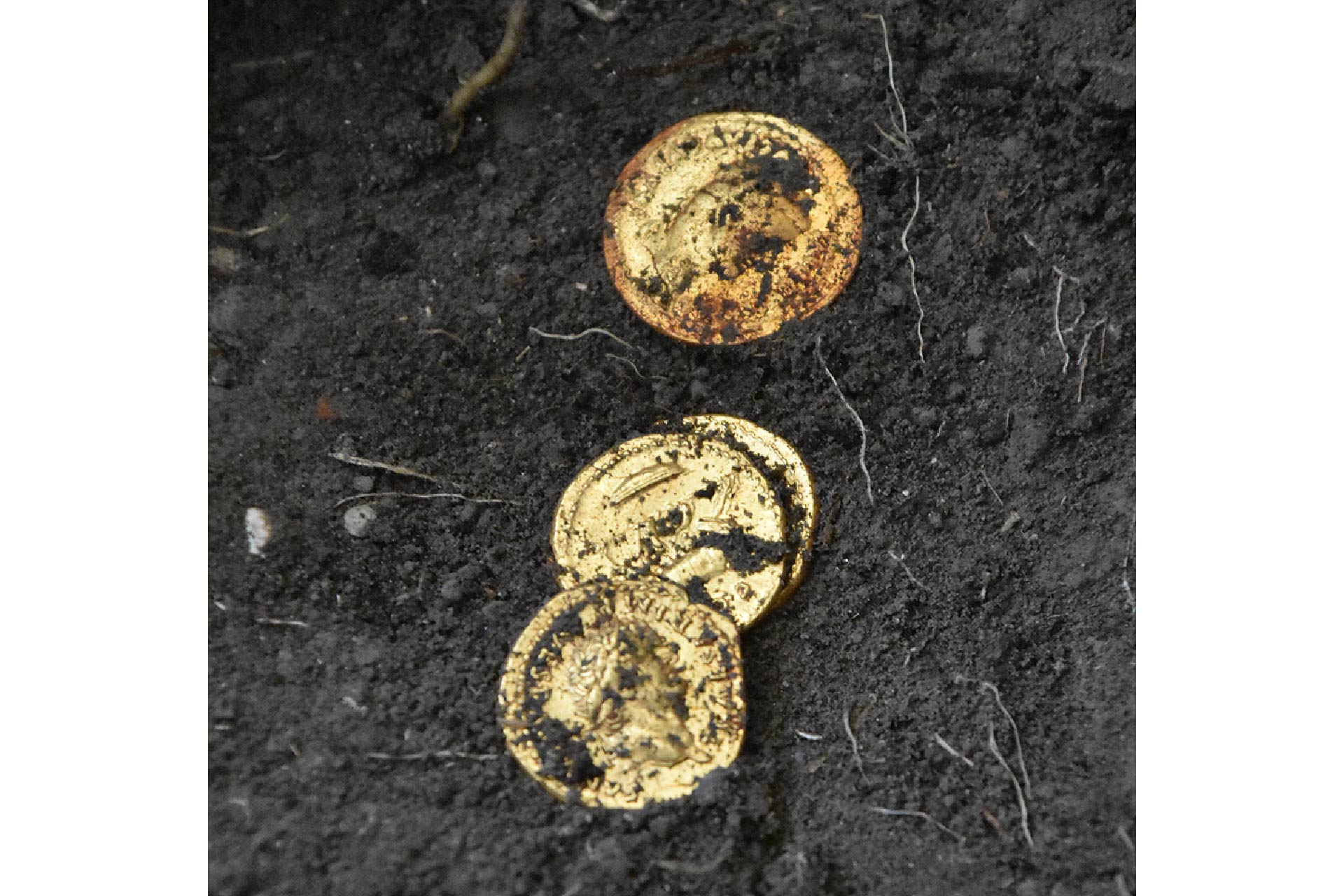 three gold coins found on the ash deposit in a room in Pompeii