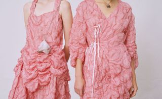 Models wear pink dresses