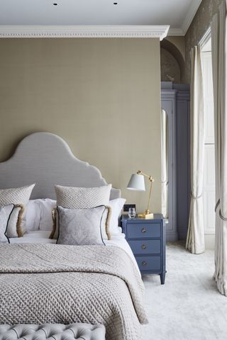 neutral masculine bedroom with grey and blue furnishings by Sims Hilditch