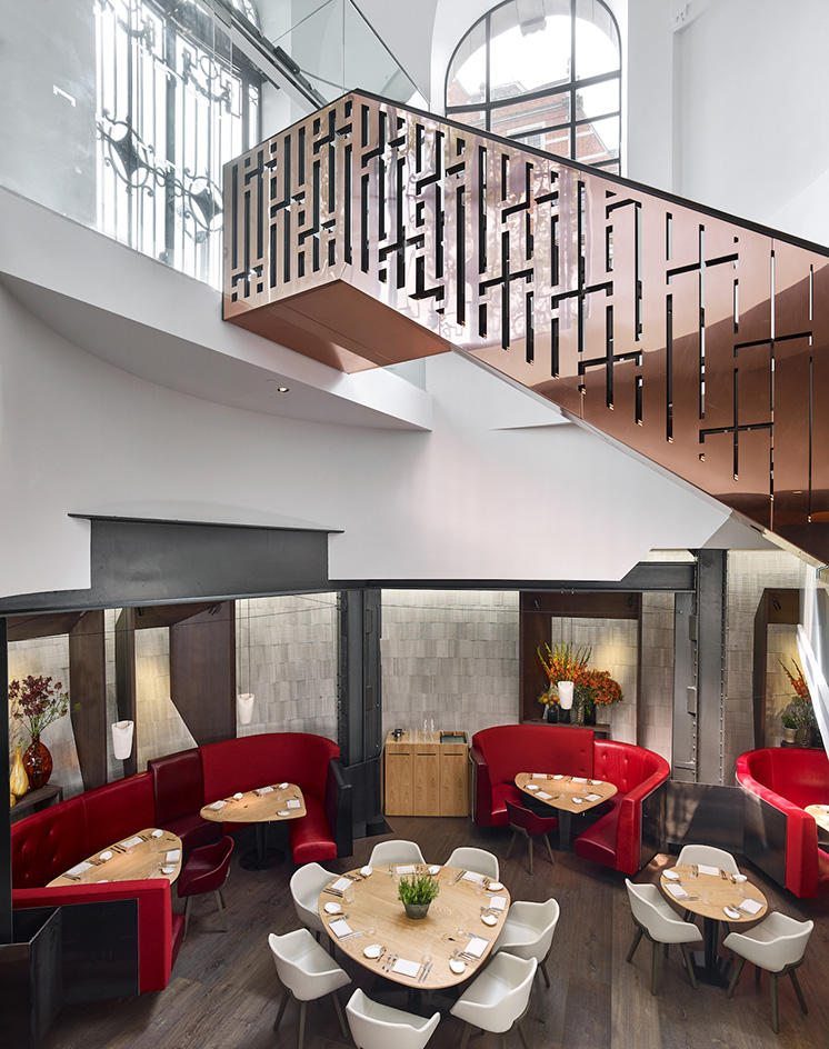 Restaurant dinning space with white chairs and wooden table