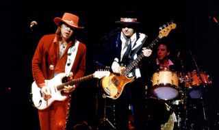 (from left) Stevie Ray Vaughan, Tommy Shannon, and Chris Layton perform onstage in 1986