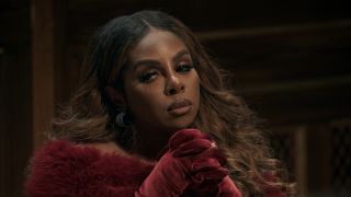 Candiace with her hands crossed at the Traitors round table. 