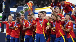 Spain players celebrate with the European Championship trophy after winning Euro 2024.