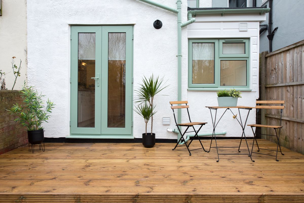 small white house with decking outside