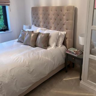 before shot of bedroom with grey bed and white bedding