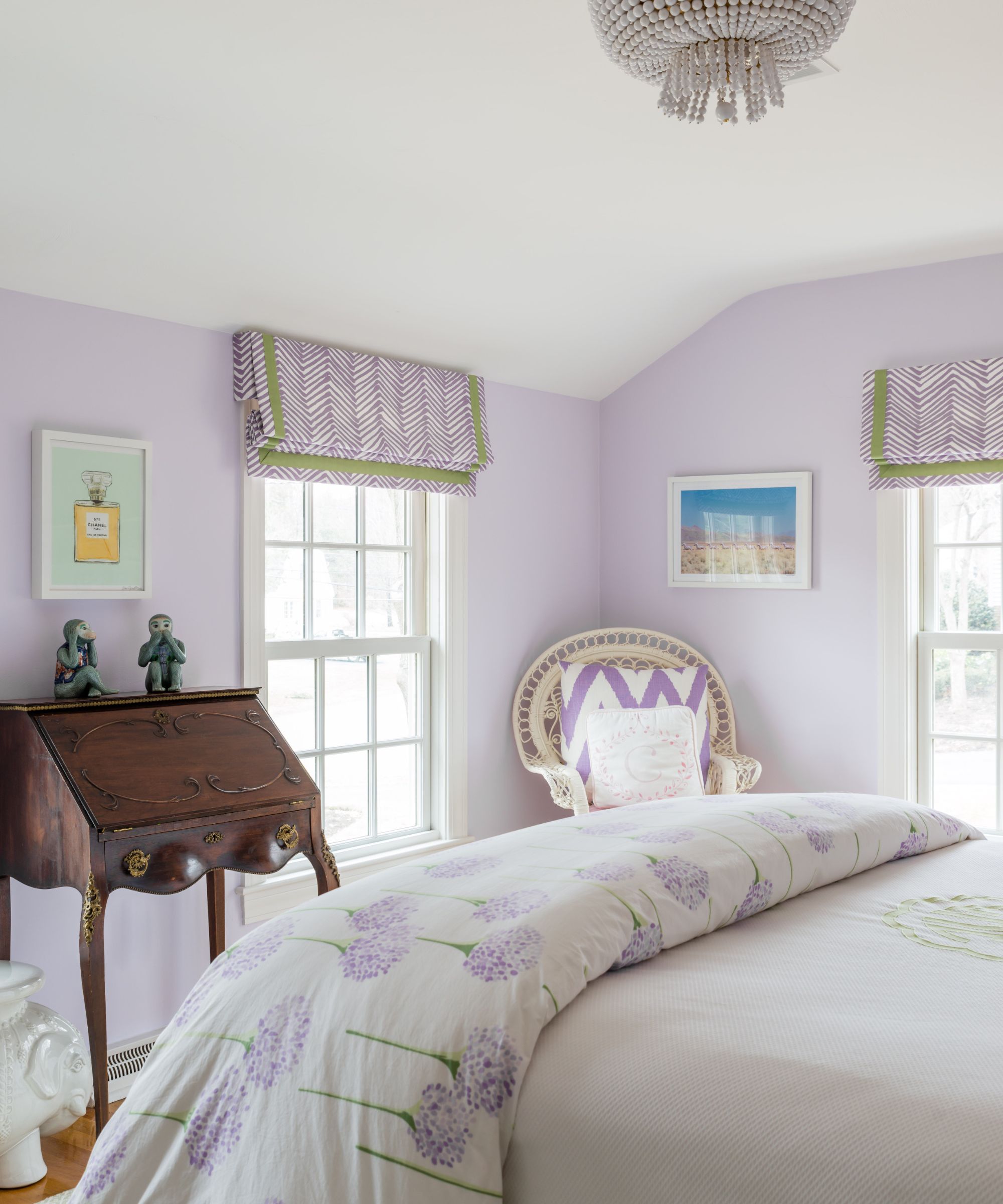 traditional bedroom with lilac walls, white sloped ceiling and traditional decor