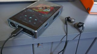 Skullcandy Set USB-C earbuds inserted in FiiO M11S music player