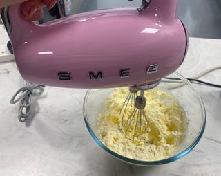 Image of Smeg retro hand mixer during whipped cream test