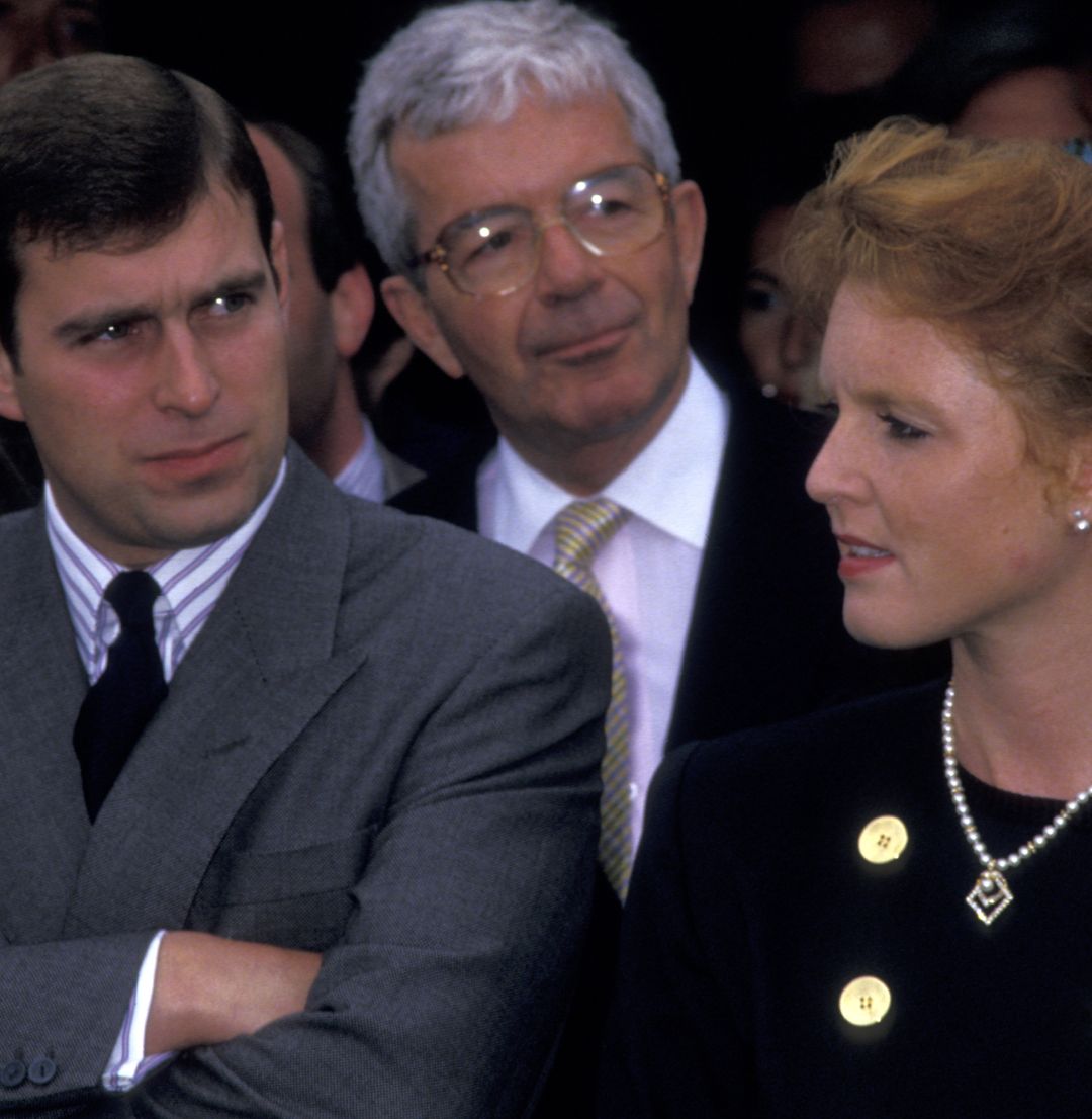 Prince Andrew folding his arms standing next to Sarah Ferguson