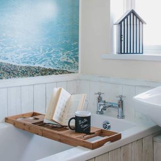 bathroom with bathtub and wooden tray