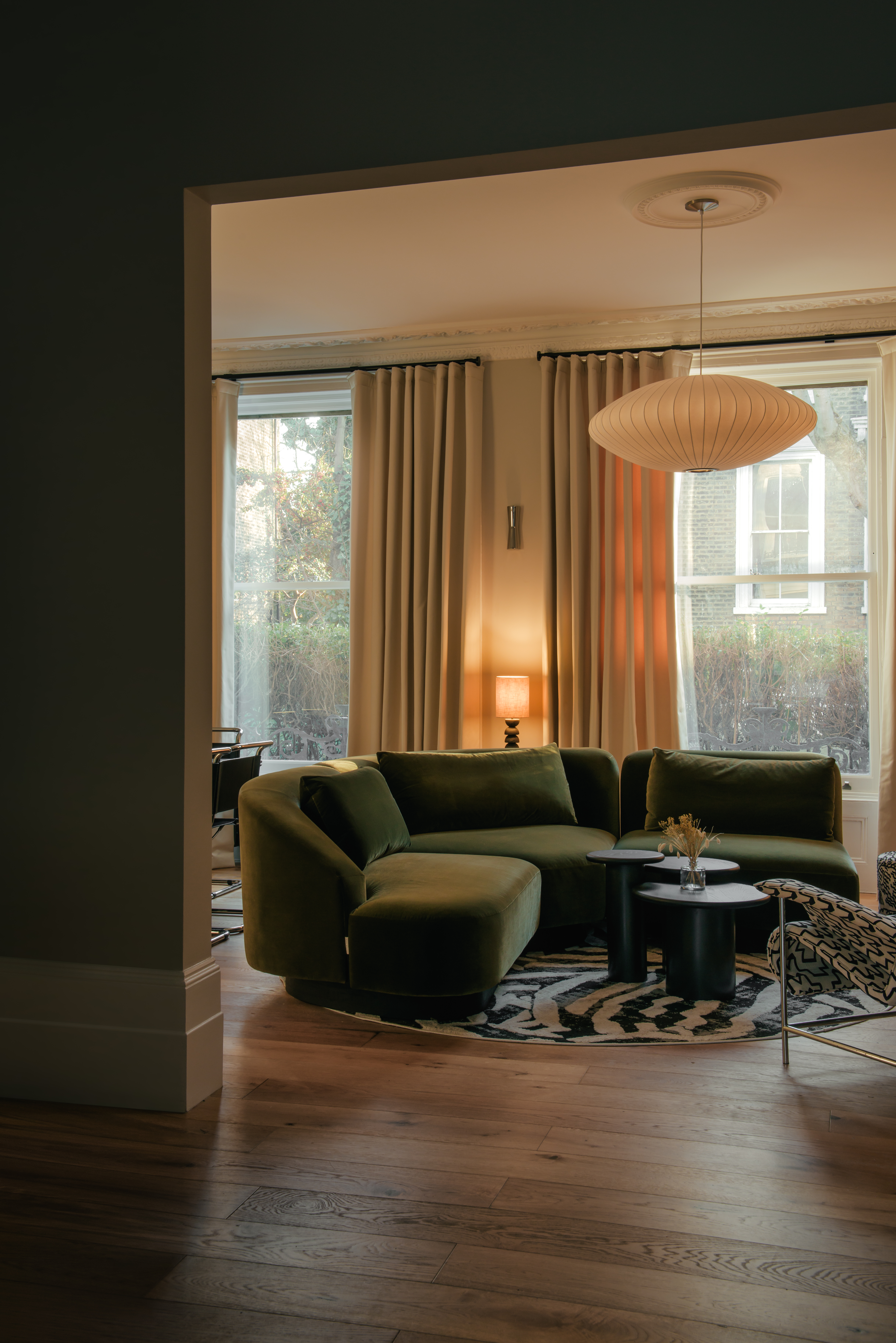 Naturally or beautifully lit rooms distinguished by an earthy palette of cream, green, and wood tones, sleek details, and textural surfaces in fabric, stone, and wood, and softly glowing lighting.