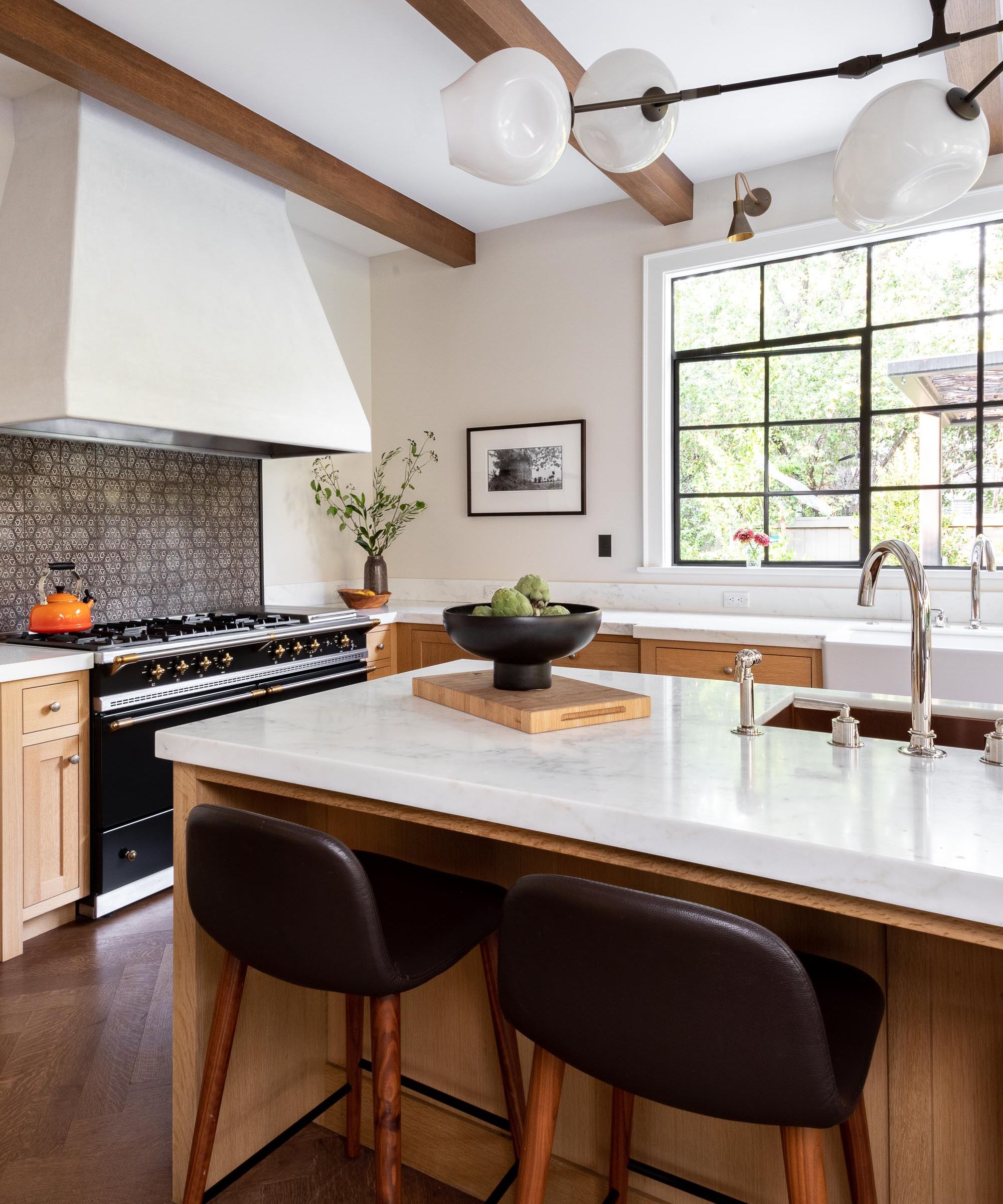 A transitional kitchen with wooden cabinets, white countertops, and patterned tiles for the backsplash