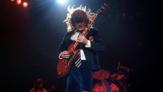 Angus Young performs with AC/DC at the Joe Louis Arena in Detroit, Michigan on November 17, 1983