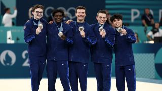 The 2024 US Men&#039;s Olympics Gymnastics team celebrate with their bronze medals.