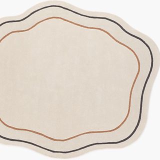 A round beige rug with borderline