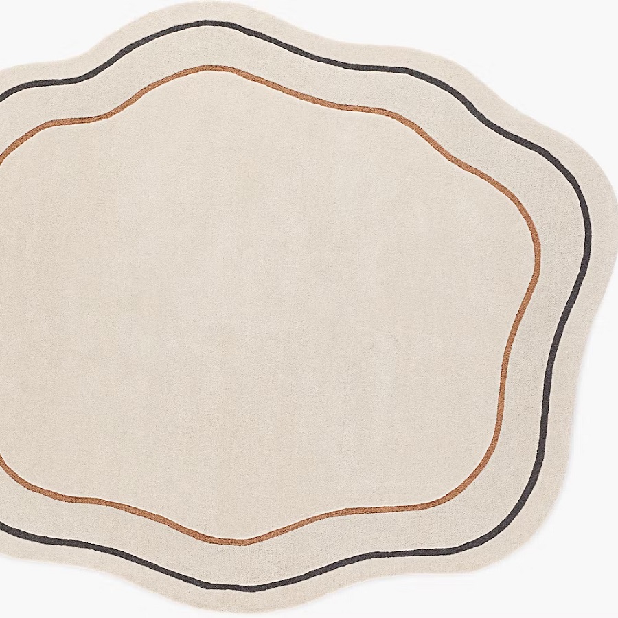 What does a round rug do to a room?