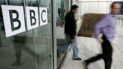 People leave the BBC building, in the corporation's West London headquarters, 21 March 2005. The BBC is to axe 2050 jobs in a second wave of cuts to save hundreds of millions of pounds, the c