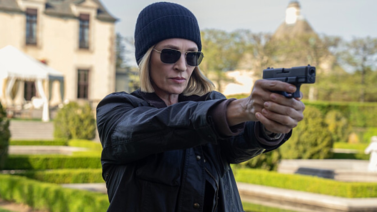 Charley aiming her gun at Red