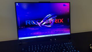Asus ROG Strix Scar 18 gaming laptop screen open on a black table