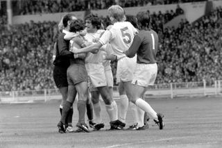 Hunter and referee Reg Matthewson try to break up a fight between Leeds midfielder Billy Bremner and Liverpool forward Kevin Keegan during the 1974 Charity Shield at Wembley