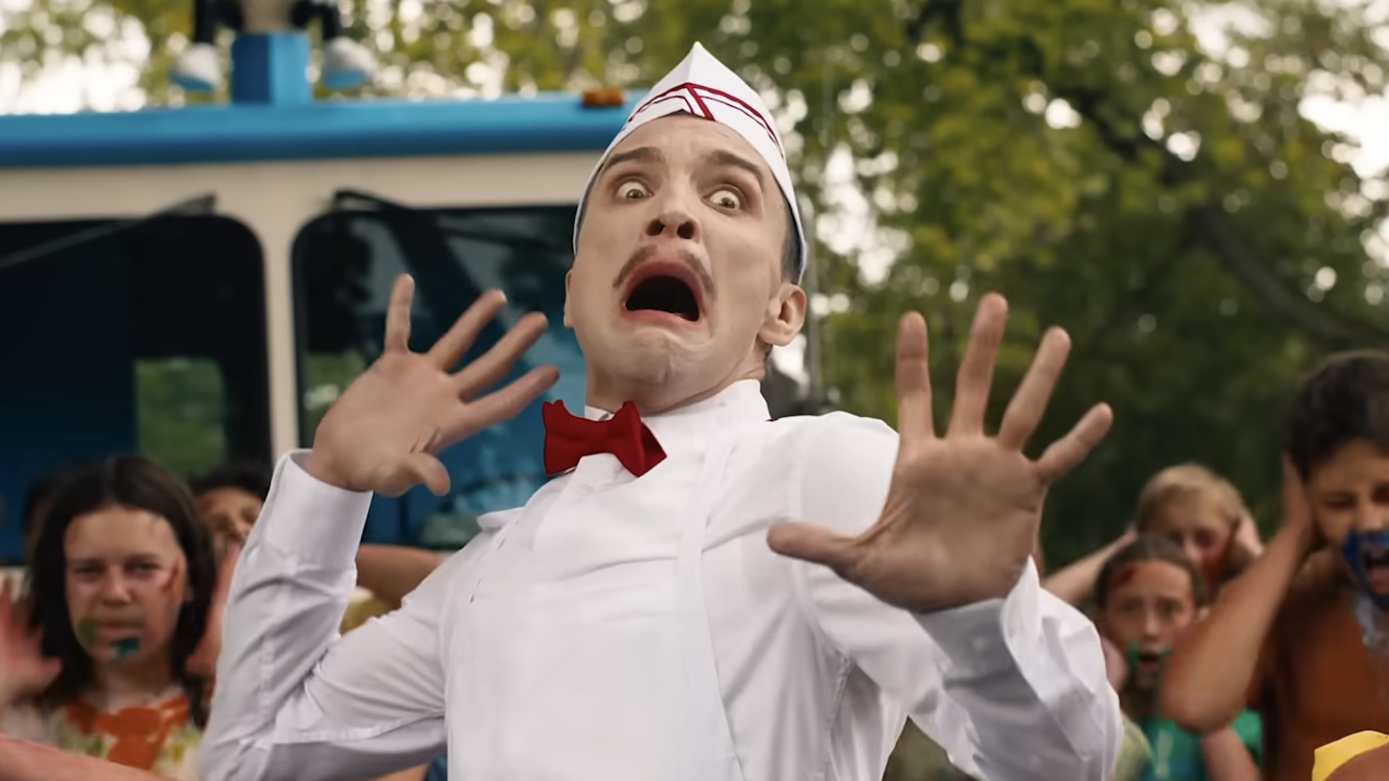 Ice Cream Man screaming with lots of bloody-faced kids surrounding him in Ice Cream Man