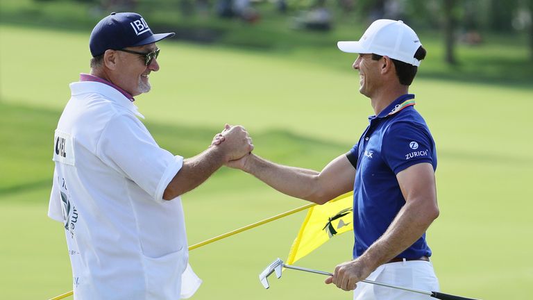 Billy Horschel celebrates with his caddie after winning the 2022 Memorial