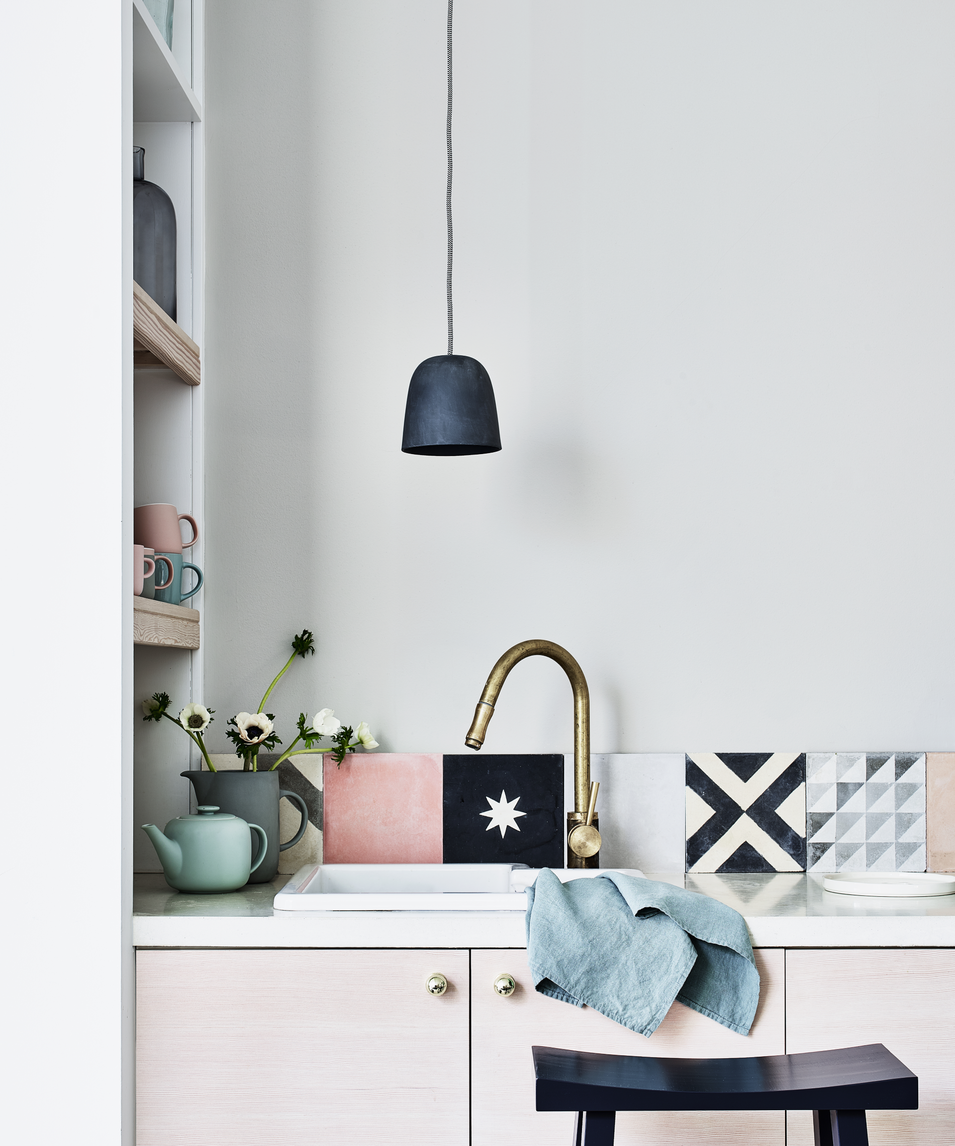 Kitchen color ideas in a neutral pale gray kitchen with colorful pops through navy and pink tiles.