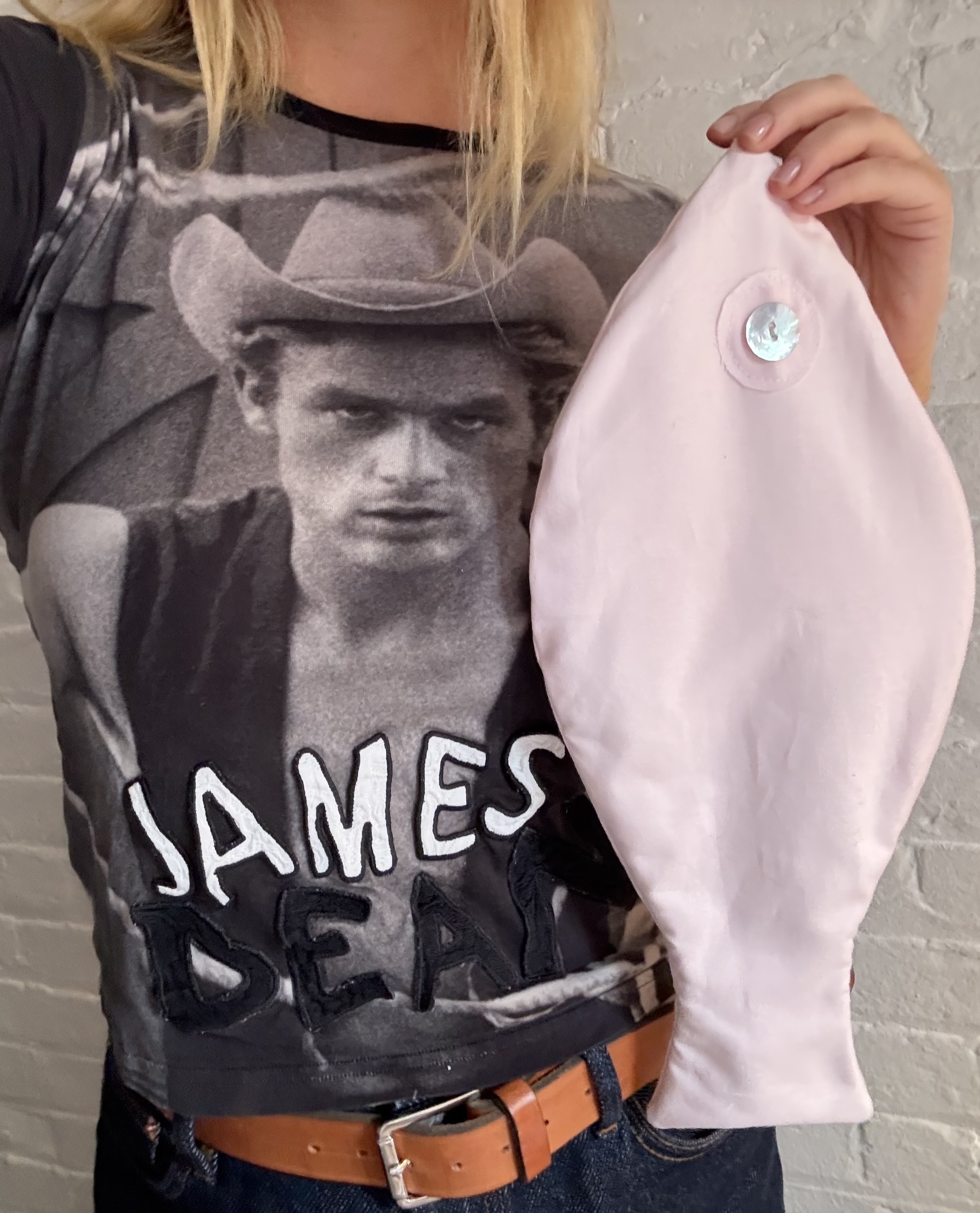 Martine Lavelle wearing a James Dean shirt holding a Tonset Road fish bag in pink