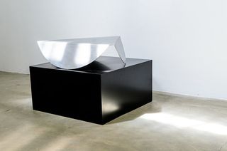 Black box table with metal sculpture on top