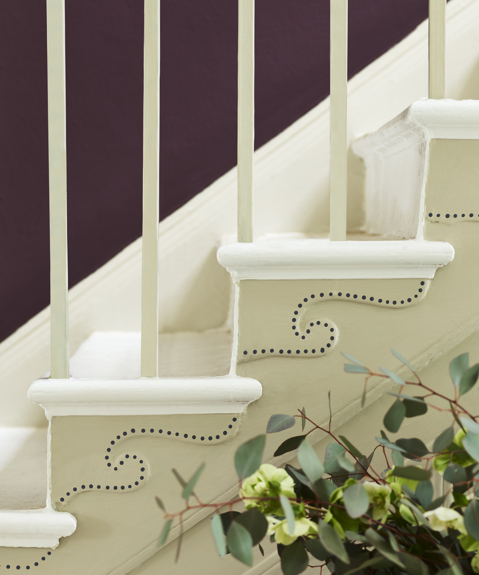cream and white painted stairs with decorative wave and dotted pattern on side of staircase