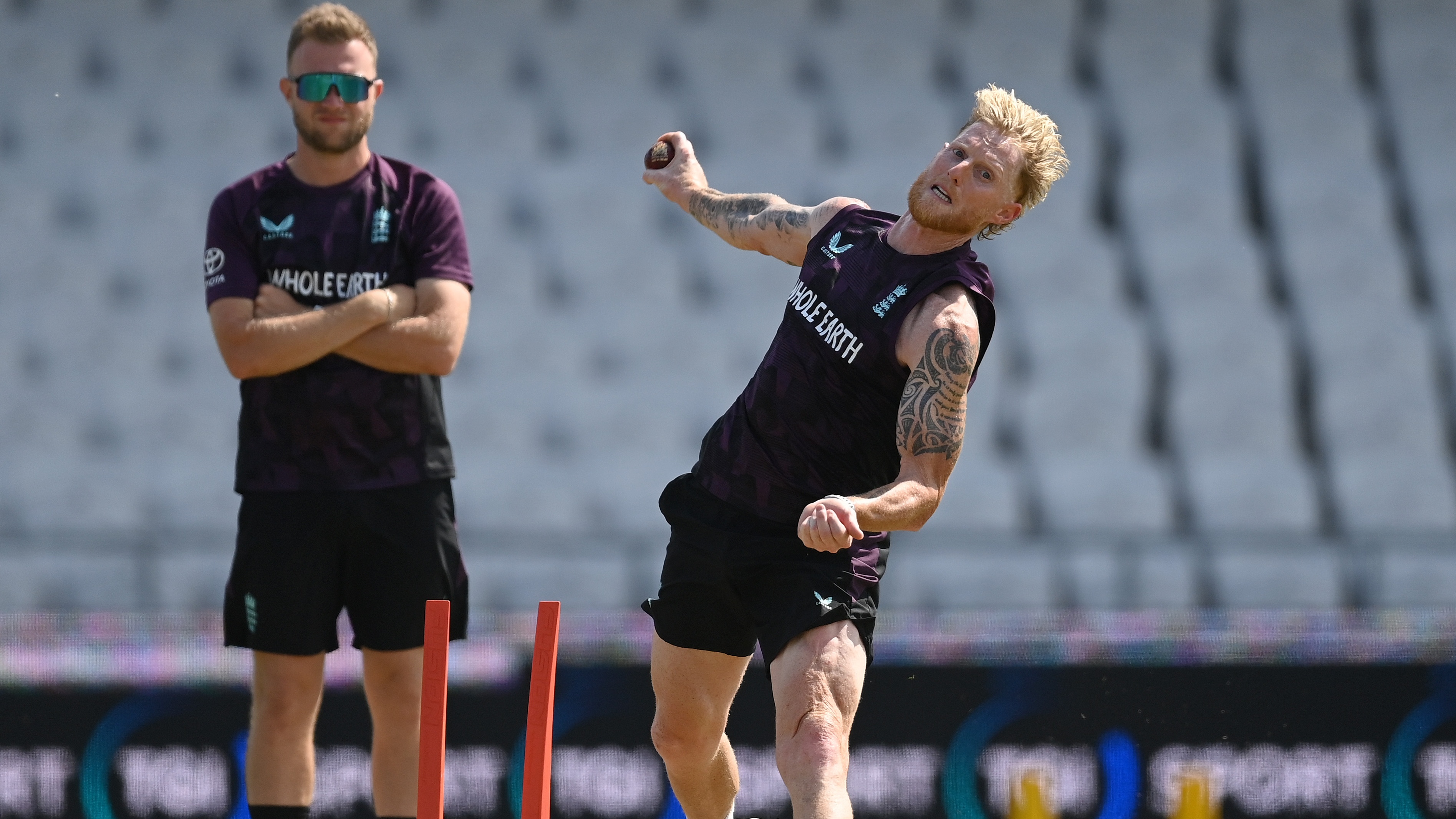 Ben Stokes bowls a ball in training for England as Sam Cook of Essex looks on.