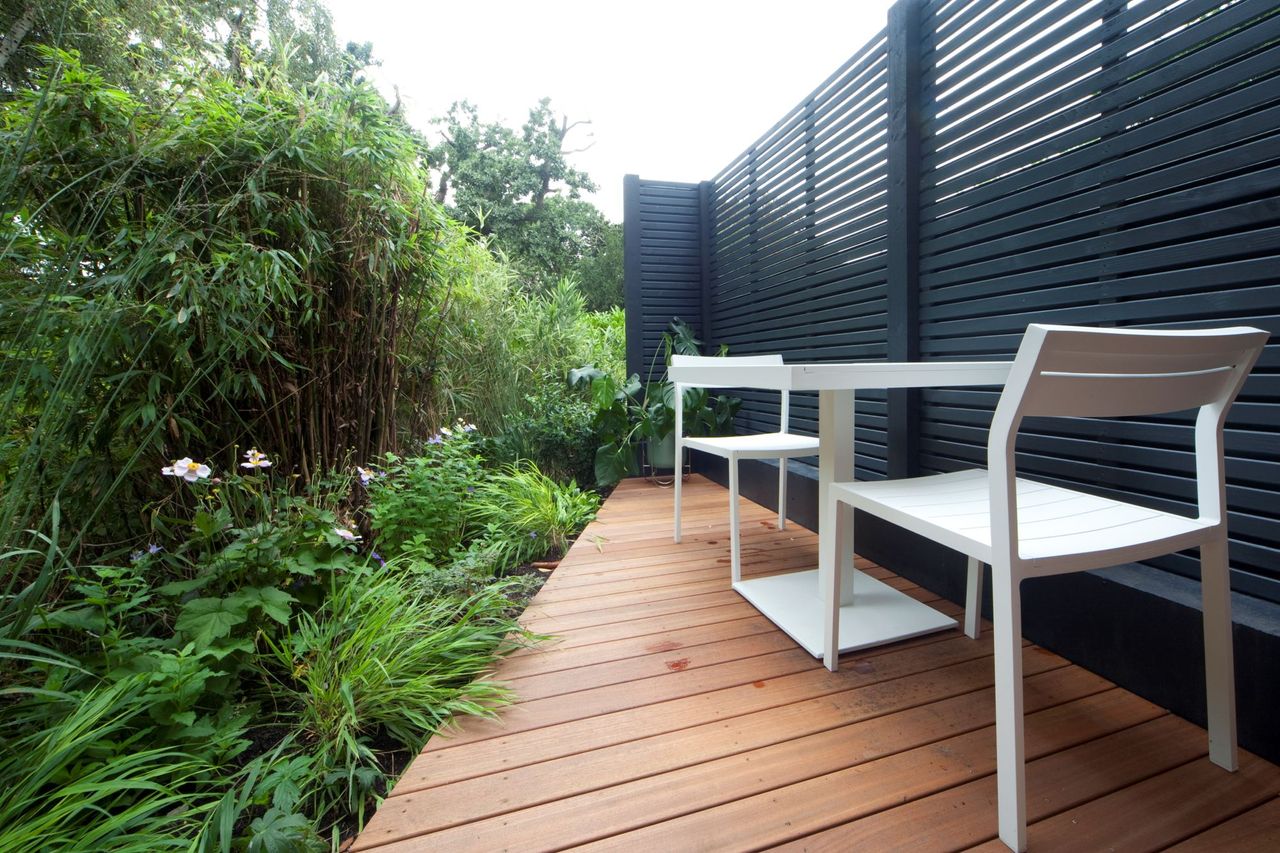 Decking for the triangle home with a table and chairs on it