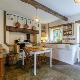kitchen with wooden fixtures and stone flooring
