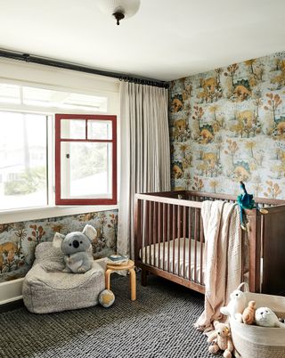 children's room with dinosaur wallpaper and wooden cot