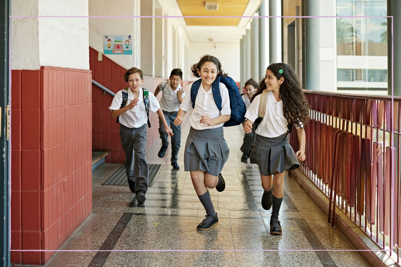 When do kids break up from school as illustrated by children running out of school